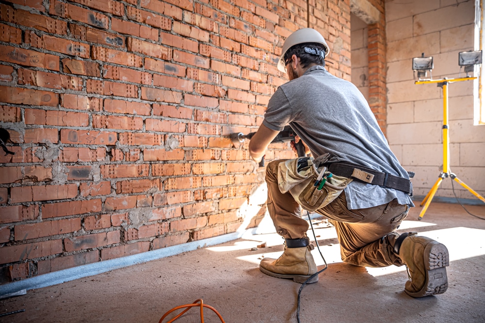 Handyman,At,A,Construction,Site,In,The,Process,Of,Drilling